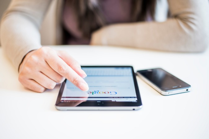 Image of woman using Google My Business on her tablet