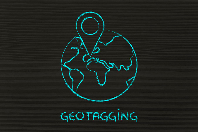 An image showing a drawing of Earth with the geotagging symbol sticking out of it.