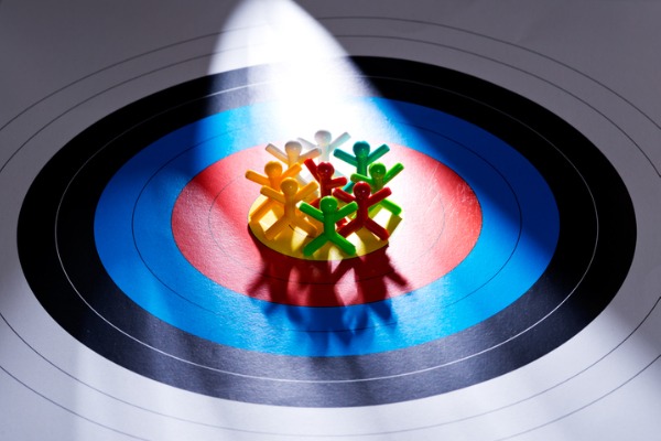 A graphic image showing symbols for people clustered inside of a bullseye on a target.