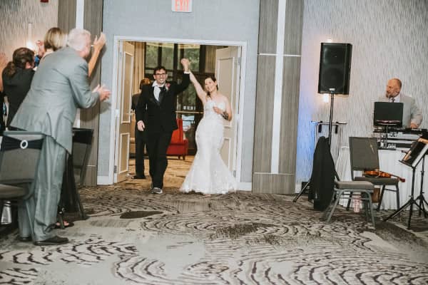 Joe and Brenda entering their wedding reception