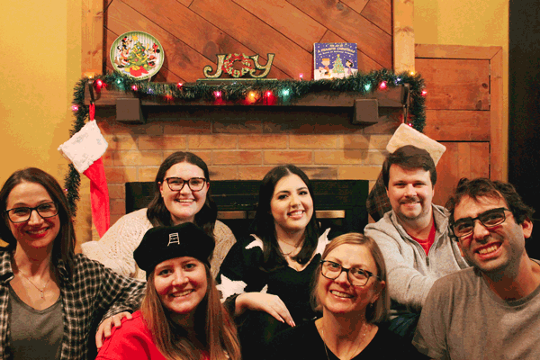 Group photo of the Frontier Marketing team in front of a fireplace