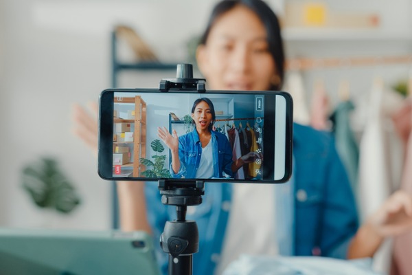 Woman recording a video to post on social media.