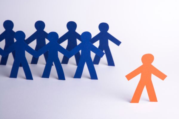An orange figure stands out from a crowd of blue figures