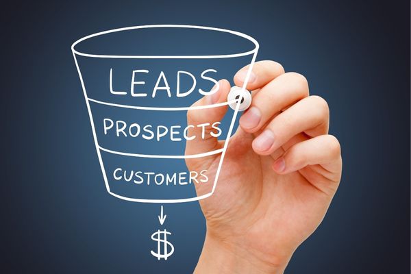 Hand drawing a marketing funnel on a clear screen
