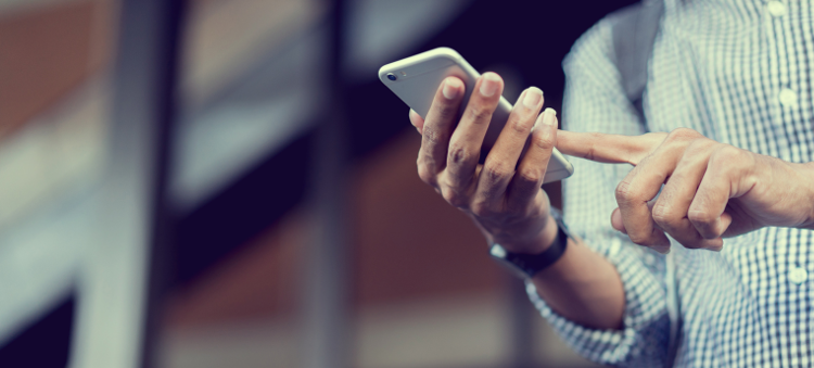 Image of man holding a cell phone to illustrate SEO best practices.