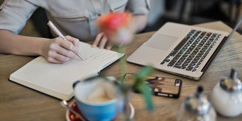 A person sits at a desk and performs SEO content writing.
