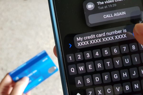 A credit card is positioned next to a cell phone where someone has put in their card details