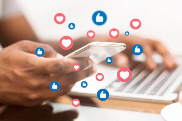 A man uses a smart phone to connect with a small business online