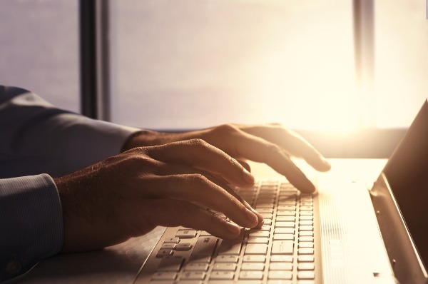 Image of two people looking at blog analytics on a tablet