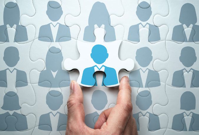 A graphic showing puzzle pieces with people icons on each piece. The final piece is being placed in the puzzle. 
