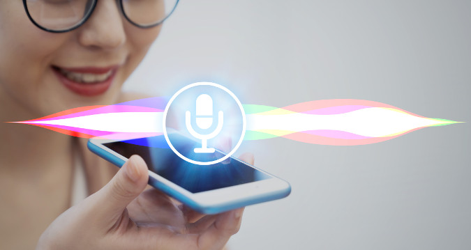 Image of a woman using voice recognition on a cell phone to illustrate local citations.