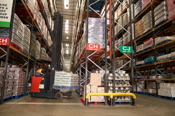 An image showing the stocking of inventory inside of a warehouse.