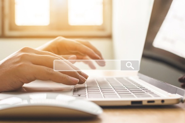 An image showing a laptop with a search bar highlighted over it. 