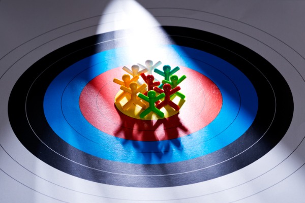 A graphic image showing symbols for people clustered inside of a bullseye on a target. 